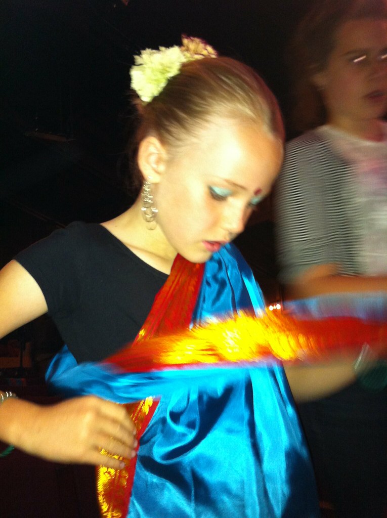 Dancer preparing for a classical performance in a traditional dance studio